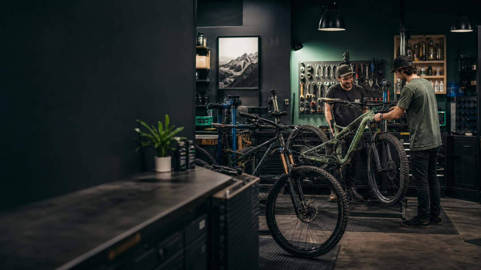 Mountain bike mechanics collaborating at a professional workbench